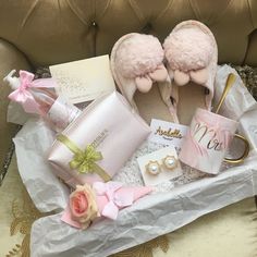 a pair of pink slippers sitting on top of a table next to other items