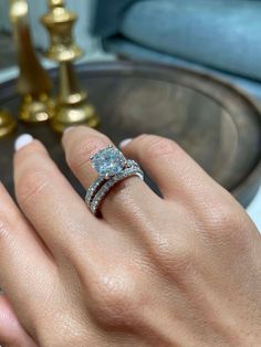 a woman's hand with a diamond ring on it