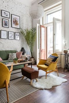 a living room filled with furniture and pictures on the wall