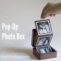 a hand holding an open box with two pictures in it and the words pop - up photo box above it