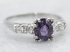 This extraordinary ring is crafted from platinum, featuring deeply purple sapphire and stunning diamonds for gorgeous sparkle. Perfect for adding a touch of luxury to every occasion, this exquisite jewelry piece is sure to become an heirloom.Metal: PlatinumGem: Purple Sapphire 1.40 CaratsGem Measurements: 5.6 x 7.0 mm, OvalAccents: 4 Diamonds totaling .26 Carats, SI in Clarity, H in ColorRing Size: 8.25Marks: "10% IR PLAT" Stamped on the inside band Purple Sapphire Ring, Pink Sapphire Ring, Purple Sapphire, Ring With Diamond, Exquisite Jewelry, Pink Sapphire, Sapphire Ring, Jewelry Pieces, Platinum