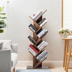 a tall wooden book shelf sitting in the corner of a living room