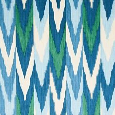 a blue, green and white fabric with an interesting pattern on it's surface