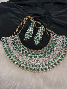 American Diamond Emerald Green Stone Choker Grand looking Statement choker necklace in green trendy collection. Good addition in wardrobe for any coming up weddings, receptions or festivals. Pair it up with contrast lehenga or designer saree. Necklace comes with back chain Earrings Length : 2.75 Inches; Push Back Ready to ship from Boston, MA Contrast Lehenga, Green Stone Choker, Saree Necklace, Emerald Green Stone, Back Chain, Jewelry Pakistani, Bridal Choker, Stone Choker, Weddings Receptions