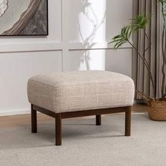 a living room scene with focus on the footstool