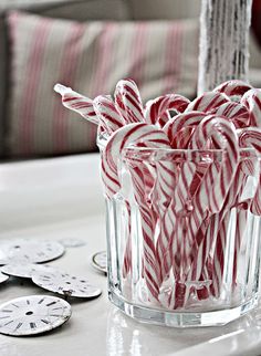 some candy canes in a glass on a table