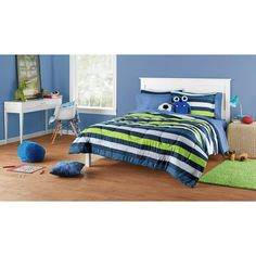 a child's bedroom with blue walls and wooden floors, including a white bed