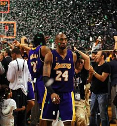 the lakers players are celebrating with confetti in front of their team's fans