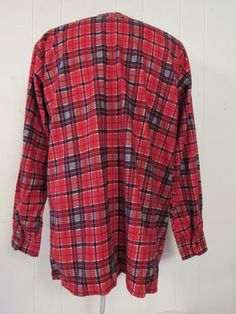 "Vintage 1970s shirt. Made of blue and red plaid cotton flannel. Features a button front, chest pocket and button cuffs. Label is missing. Size large. Actual measurements are: 45\" around the chest, 44\" at the waist, 19\" shoulder seam to shoulder seam, 24\" shoulder seam to end of cuff, 30\" overall length. In excellent unused condition. New old stock." 1950s Shirts, 1970s Dresses, Red Flannel, Hawaiian Dress, Vintage Hawaiian, Vintage Shirt, Work Shirts, Cotton Flannel, Vintage 1970s