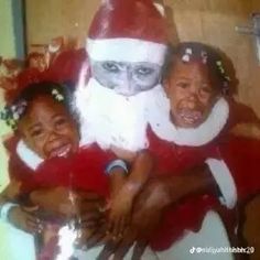 an old photo of two children dressed up as santa clause and the cat in the hat