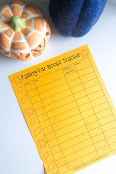 a table with a pumpkin and some sort of activity for kids to do on halloween