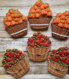 cupcakes decorated with chocolate icing and pumpkins in baskets on a wooden table