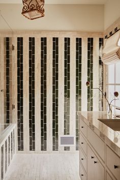 a bathroom with black and white tiles on the walls