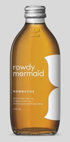 a bottle of kombucha from rowdy mermaid on a gray background with the words kombucha written in white