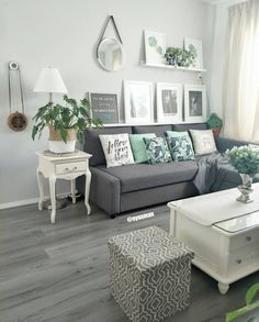 a living room filled with lots of furniture and pictures on the wall above it's coffee table