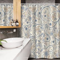 a bathroom with a sink, mirror and shower curtain that has an artistic design on it