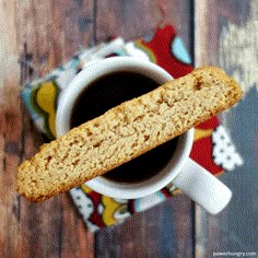 a cup of coffee and some type of biscuit