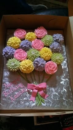 a birthday cake in a box decorated with flowers