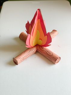 an origami fire on a white table