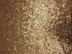 an image of gold glitter textured paper with some brown and white dots on it