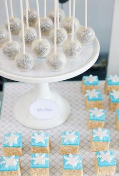 cake pops and marshmallows are arranged on a table