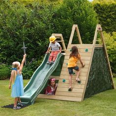 three children are playing on a wooden slide