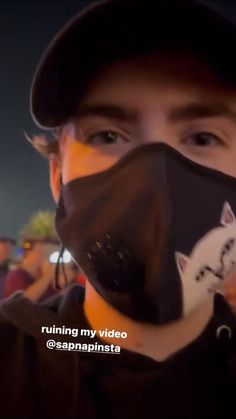 a man wearing a face mask with a cat on it