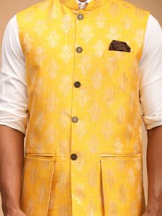 SHRESTHA By VASTRAMAY Men's Yellow Woven Flap Ethnic Jacket Add a touch of ethnic elegance to your wardrobe with this yellow woven flap jacket for men. Crafted with care, this jacket features a unique design that blends traditional style with modern sensibilities. Perfect for special occasions or casual outings, this jacket is sure to make you stand out in style. Features: Ethnic jacket for men Yellow color with woven flap design Blend of traditional and modern style Suitable for special occasio Traditional Fitted Nehru Jacket With Pockets, Traditional Yellow Nehru Jacket For Festivals, Traditional Gold Outerwear For Winter, Traditional Yellow Outerwear For Fall, Fitted Yellow Nehru Jacket With Long Sleeves, Fitted Yellow Nehru Jacket, Yellow Long Sleeve Nehru Jacket For Festivals, Traditional Gold Winter Outerwear, Traditional Yellow Fall Outerwear