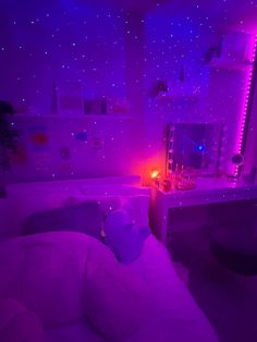 a purple room with stars on the ceiling and a bed in front of a mirror