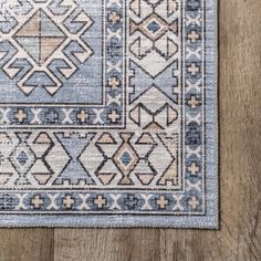 a blue and pink rug on top of a wooden floor