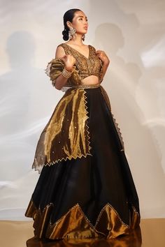 Black, gold attached cancan lehenga with cutdana, sequin embroidered border. Paired with sleeveless embroidered padded blouse and cutwork bordered dupatta. - Aza Fashions Evening Organza Lehenga With Cutdana, Gold Dupatta Sets For Evening, Gold Party Wear Sets For Evening, Gold Evening Set With Dupatta, Gold Embellished Lehenga In Tissue Silk, Organza Lehenga With Gold Embroidery For Reception, Gold Embroidered Organza Lehenga For Reception, Gold Anarkali Lehenga For Evening, Anarkali Gold Lehenga For Evening