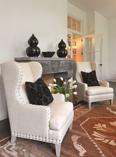 a living room filled with furniture and a fire place