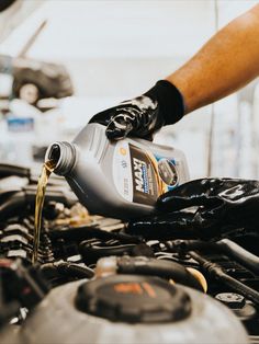 a person pouring oil into a car engine Car Mechanic Aesthetic, Mechanic Photography, Mechanics Photography, Oil Change Service, Car Oil Change, Mechanics Aesthetic, Car Oil, Automobile Advertising, Auto Mechanic