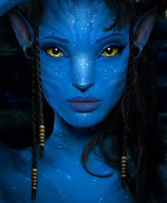 a woman with blue skin and yellow eyes is dressed as avatar from the movie avatar avatar avatar