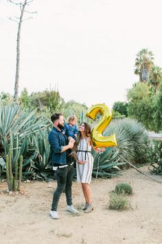 a man and woman holding a child in their arms with the number twenty two on them