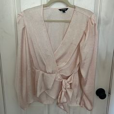 I Am Selling A Baby Pink Long Sleeve Blouse With A White Floral Print. The Blouse Is A Peplum Style With A Fake Tie Waist. The Blouse Was Never Worn. It Is A Size Large And Is By The Brand Express. Casual Wrap Top For Party, Spring Party Wrap Tops, Pink Wrap Top For Spring, Spring Wrap Tops For Brunch, Spring Wrap Top For Brunch, Spring Brunch Wrap Top, Feminine Pink V-neck Blouse, Pink Floral Print V-neck Blouse, Pink V-neck Blouse With Button Closure