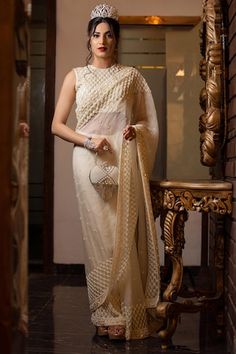 Ivory sequin and bead embroidered saree. Paired with an all over embroidered checkered pattern padded blouse and petticoat. - Aza Fashions Off White Designer Pre-draped Saree For Festive Occasions, Elegant Off White Pre-draped Saree With Resham Embroidery, Elegant Chikankari Pre-draped Saree For Reception, Off White Blouse Piece For Reception With Traditional Drape, Off White Pre-draped Saree With Zari Work For Reception, Off White Traditional Drape Blouse Piece For Reception, Off-white Pre-draped Saree With Zari Work For Reception, Bollywood Style Pre-draped Saree With Pearl Embroidery For Reception, Elegant Off White Pre-draped Saree With Zari Work