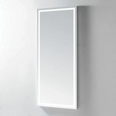 a bathroom mirror mounted to the side of a wall