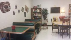 tables and chairs are lined up in the corner of a room with bookshelves