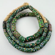 A graduated long strand of antique Venetian trade beads. This strand was put together over 25 years ago - it would be hard to find such well matched beads and graduated too. 52 beads 25" of beads 64cm 31" strand with raffia 6 to 10mm diameter  2mm hole Traditional Single Strand Oval Beads, Traditional Green Spacer Beads, Traditional Green Hand-strung Beads, African Trade Beads, Trade Beads, Hard To Find, 25 Years, Seattle, Accessory Gift