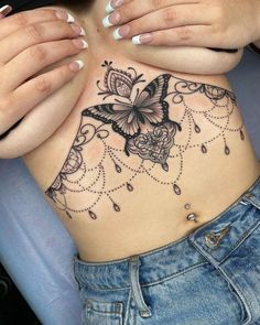 a woman's stomach with a butterfly tattoo on her belly and the bottom part of her stomach