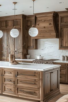 a large kitchen with wooden cabinets and marble counter tops, along with two pendant lights hanging from the ceiling