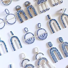 the letters and numbers are made out of blue and white ceramic beads, with geometric designs on them