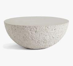 a white concrete bowl sitting on top of a table