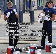 two men in blue shirts and white gloves are playing musical instruments on the street while another man is holding a trumpet