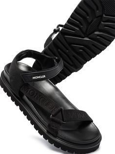 Moncler Flavia Flat Sandals - Farfetch Black Leather Sport Sandals With Strap, Black Leather Strap Sport Sandals, Black Sandals With Logo Strap For Summer, Black Open Toe Sport Sandals With Logo Strap, Summer Sandals With Logo Strap And Round Toe, Leather Sport Sandals With Logo Strap For Summer, Casual Black Sandals With Logo Strap, Black Sport Sandals With Logo Strap For Summer, Flat Leather Sport Sandals With Rubber Sole