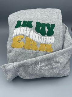 This sweatshirt is the must have for your World Qualifier. What could be more special than a super soft hoodie with custom embroidery? It is a keepsake in addition to what will be their new favorite hoodie. Celebrate in style! The colors are the Irish Flag of course, embroidered by our friends at Irish Stitch Embroidery. You have your choice of a grey or black hoodie and could have a classic hoodie OR we can add some bedazzle with a sparkle rope. Our processing time is 5 days, please take note. Dance Sweatshirt, Irish Step Dancing, Dance Teacher Gifts, Irish Dancers, Irish Flag, Dance Gifts, Wear Store, Christmas School, Dance Teacher