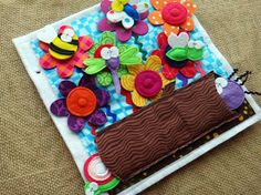 a close up of a piece of cloth with buttons on it and flowers in the center