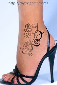 a woman's foot with a tattoo on the side of her leg and heels