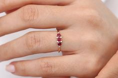 "14k Gold Ruby Ring / Dainty Ruby Ring / Ruby Stacking Ring / Natural Ruby / Promise Ring / Ruby and Diamond Ring / Statement Ring Ferkos Fine Jewelry Features ✔Made to Order ✔Gold Kt: 14K (also available in 18K) ✔Available Gold Color: Rose Gold, Yellow Gold, White Gold ✔Round Ruby: 3 pcs 3.0 MM ✔Round Diamond: 6 pcs 1.2 MM ✔Number of Stones: 9 ✔Ruby CTW: 0.33 ctw ✔Diamond CTW: 0.04 ctw ✔Ready to Ship in 7-10 Business Days ★ ★ ★ Each order will be beautifully packaged for gift giving in a jewelr 14k Gold Three Stone Red Rings, Red Three Stone 14k Gold Rings, 14k Gold Three Stone Ruby Promise Ring, 14k Gold Three Stone Ruby Ring For Anniversary, Ruby Ring Simple, Ruby Promise Ring, Ruby Ring Designs, Dainty Ruby Ring, 14k Gold Ruby Ring